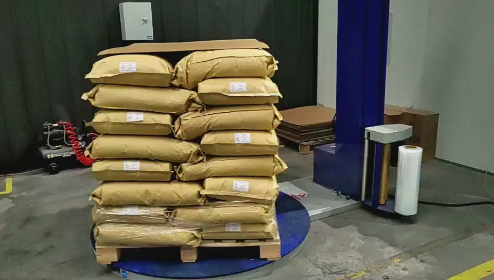 Demonstration of semi-automatic wrapping machine featuring rotating turntable system with adjustable tension control for efficient pallet wrapping. The turntable stretch wrapper handles loads up to 2000kg with maximum packaging dimensions of 1400mm diameter and 1800mm height. Features 1500mm diameter turntable with adjustable speed from 0-12 rpm for consistent wrapping coverage. Pre-stretch system and film saving technology reduce material consumption while maintaining secure load containment. Safety guard.