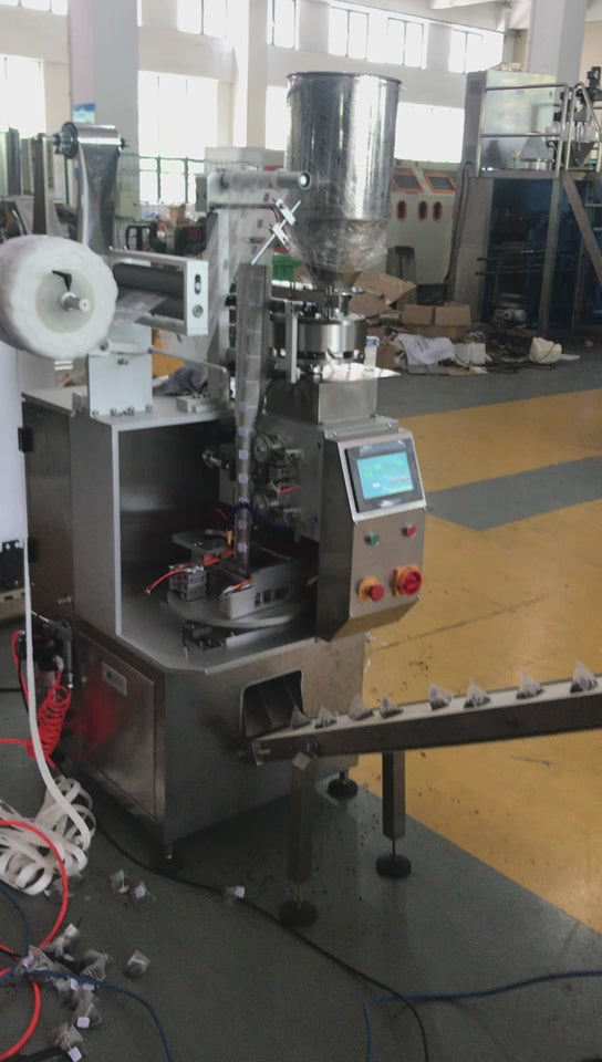Triangle tea bag machine producing pyramid tea bags with hanging string and paper tag for premium retail tea and herbal beverage packaging