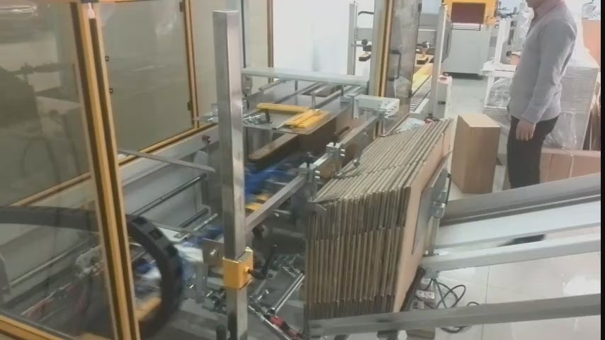 Demonstration of Keypack Intelligent servo automatic carton erector performing box forming operations. Features dual servo motor drive for precise positioning, tilt-type magazine for continuous carton feeding, and pneumatic forming system. Capacity: 5-15 cartons/minute. Suitable for food packaging, pharmaceutical production, and industrial automation applications.
